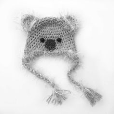 a crocheted hat with a bear on the front and side, made to look like an animal