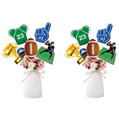 two vases filled with flowers and sports related items, each holding a football ornament