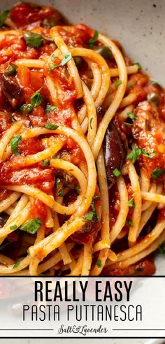 pasta with tomato sauce and olives in a white bowl