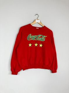 Vintage Rare COCA COLA Women Cropped Crewneck Sweatshirt Big Logo Coca Cola Jumper Pullover Coca Cola Sweater Red Colour Large Size CONDITION :- ✅GOODUSED CONDITION. ✅NO STAINS  ✅NO HOLE ITEM DESCRIPTION:- ✅SIZE: 160 ✅MATERIAL : COTTON ✅THIS USED & VINTAGE ITEMS, SO DON'T EXPECTED IT TO BE LIKE NEW CONDITION!! MEASUREMENT: ✅ARMPIT TO ARMPIT : 21.5 INCH ✅LENGHT NECK TO : 20.5 INCH  ✅SHOULDHER : 21 INCH ✅SLEEVE: 18.5 INCH PLEASE REFER PHOTO BEFORE ORDER √ALL MEASUREMENTS ARE TAKEN WITH THE GARMENT FLAT ON THE GROUND √WE SHIP BY POST VIA MALAYSIA INTERNATIONAL REGISTERED/SIGNED FOR WITH TRACKING NO. TRACKING NUMBER WILL BE GIVEN. √THE PARCEL WILL BE ARRIVE WITHIN 10-14 WORKING DAYS OR MORE DUE TO THE LOCATION & CUSTOMS CLEARINGS. √BUYER DON'T HESITATE TO ASK ME IF ANY INQUIRY ABOUT ITEM BEFOR Red Long Sleeve Sweatshirt, Retro Crew Neck Tops For Winter, Red Crew Neck Sweater For Fall, Christmas Streetwear Long Sleeve Sweater, Retro Red Long Sleeve Sweatshirt, Red Retro Long Sleeve Sweatshirt, Christmas Long Sleeve Streetwear Sweater, Christmas Long Sleeve Sweater For Streetwear, Red Vintage Crew Sweater