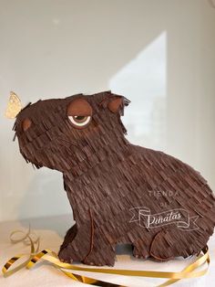 a cake shaped like a bear with a butterfly on its head