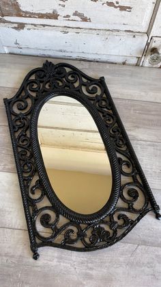 a mirror sitting on top of a wooden floor