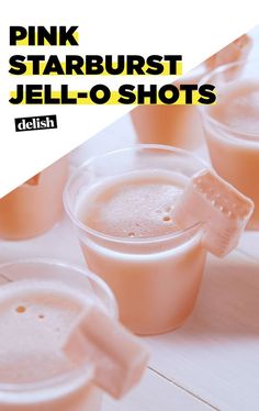 pink starburst jello shots in plastic cups on a white table with text overlay that reads, pink starburst jello shots