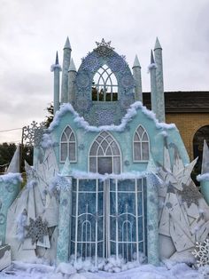 a building made out of ice and snow with frost on the windows, doors and arches