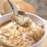 a spoon full of food in a white bowl