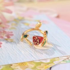 Indulge in the beauty of love and passion with our Rose Enamel Ring. Handcrafted with delicate and sophisticated touches, this romantic piece is adorned with a stunning rose design. Its eye-catching and adorable appeal is suitable for any occasion, making it the perfect addition to your jewelry collection! DETAILS Plating: 18K Gold Materials: 18K Gold on Brass, Enamel Size: Adjustable, 0.51 "*0.47"/13mm*12mm Weight: 4.7 g Luxury Flower Shaped Enamel Ring As Gift, Delicate Rose Gold Flower Ring For Gift, Rose Gold Flower Ring For Gift, Elegant Rose Flower Ring For Gift, Elegant Rose Flower Ring As Gift, Elegant Rose-colored Flower Ring For Gift, Elegant Rose Colored Flower Ring As Gift, Elegant Rose-colored Flower Ring As Gift, Adjustable Rose Design Flower Ring As Gift