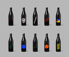 six black bottles with different designs on them