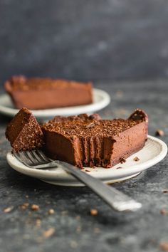 two plates with slices of chocolate cake on them