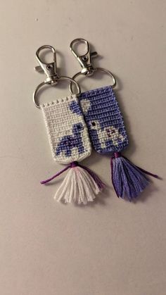 two keychains made to look like elephants with tassels