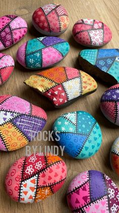 colorful painted rocks sitting on top of a wooden table