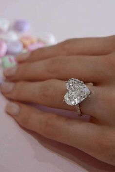 a woman's hand with a diamond ring on it