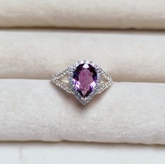 Main Stone : Natural purple amethyst Stone Color : Pink Stone Size : 10x7 mm Stone Shape : Pear Side Stone : American diamond Metal : 925 Sterling Silver Setting type : Prong setting Occasion : Engagement, Wedding ,Party, Anniversary, Valentine's Day, Daily Style : Classic Rings Type : Halo Ring Item Type : Ring Plating :silver/ gold/rose gold If You Have Any Questions, Please Feel Free Contact Us through Etsy Message Service If you want to make jewelry of some other design or other types please February Birthstone Ring, Classic Rings, Amethyst Ring Engagement, Purple Amethyst Ring, Jewelry Tattoo, Cute Rings, Daily Style, American Diamond, February Birth Stone