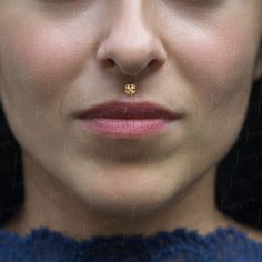 a woman with a nose piercing in front of her face