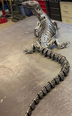 a metal lizard sitting on top of a table