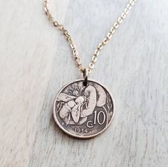 "A necklace crafted with an Italian vintage early 1900's copper coin featuring a honeybee foraging from a flower.  The number 10 appears on the front of the coin.  The reverse reads \"Vittorio Emenvele III Re D'Italia\".  I have cleaned and polished the coin leaving the darkened patina in the recesses.  The coin is a significant, measuring about 7/8\" (about 22 mm) in diameter.  This necklace makes a wonderful gift for a nature loving friend, for someone who is a beekeeper, for someone from Italy, an Italian exchange student and anyone who loves historical coins repurposed into something beautiful!   The chain is a solid red brass cable chain, crafted with a lobster clasp closure.  All chain materials are new deadstock material (vintage, but in new condition) making this entire necklace en Italian Coin Necklace, Charm Necklace Ideas, Historical Coins, Silver Casting, Copper Coin, Packing Ideas, Copper Coins, Number 10, Bee Necklace