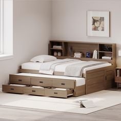 a bed with drawers underneath it in a room