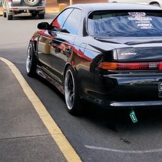 a black car parked on the side of the road