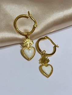 Are you looking for the perfect Valentine's day heart hoop earrings for someone special this Valentine's season? Or a unique pair of sacred heart earrings to spoil yourself? Made with tarnish-free and gold-plated stainless steel hoops and bright enamel, my vintage-style sacred heart earrings are the perfect compliment to any outfit idea! My heart dangle hoop earrings are a great gift idea for any special occasion to all the women in your life. You can't go wrong when gifting my Valentine's day e White Dangle Hoop Earrings For Valentine's Day, White Pierced Heart Earrings For Valentine's Day, White Heart Pendant Earrings, White Heart Charm Pendant Earrings, White Hoop Earrings With Heart Charm For Gift, White Huggie Earrings For Valentine's Day, White Hoop Earrings With Heart Charm, Sacred Heart Earrings, Unique Gold Earrings