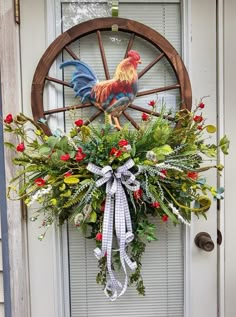 a wreath is hanging on the front door of a house with an image of a rooster