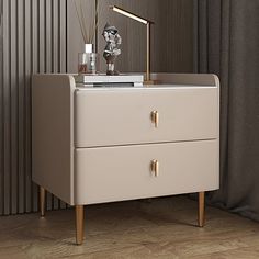 a nightstand with two drawers and a lamp on top