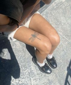 a woman with a dragon tattoo on her leg