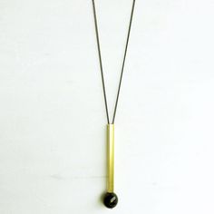 Black and Gold Long Bar and Onyx Necklace This is a great sleek and modern piece! I love this minimalist look! It's such a simple design but it's such a statement piece. It will pair great with a white tee or dress it up for a night out! You really can't go wrong with black and gold together! Have someone on your shopping list who has a great sense of style? Add to their collection with this sleek modern necklace! ➳ ITEM DETAILS: All metal is made of brass and the black bead is genuine onyx. The Gold Statement Jewelry, Lingot D'or, Black Gold Necklace, Edgy Boho, Modern Necklace, Onyx Necklace, Modern Necklaces, Necklace Long, Necklace Statement