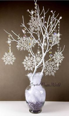 a vase filled with snowflakes on top of a table