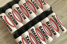 six plastic baseballs with the names of each team on them are stacked in a pile