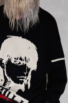 The Negative Portrait Sweater perfectly blends street style with casual comfort. The front features a striking print of a despondent portrait, accompanied by a mirrored reflection of the brand's name below. With ribbed detailing on the neckline and cuffs for a snug fit, the design is completed by a bold horizontal stripe on the left sleeve. Crafted from premium 100% cotton fabric, this slightly oversized sweater offers both comfort and a bold aesthetic. Despondent portrait print on the front Mir Edgy Graphic Print Crew Neck Sweater, Edgy Graphic Print Sweater For Winter, Edgy Streetwear Sweater, Edgy Sweater For Streetwear, Trendy Sweater With Ribbed Neckline For Streetwear, Trendy Ribbed Neckline Sweater For Streetwear, Negative Portrait, Bold Aesthetic, Sneakers And Socks