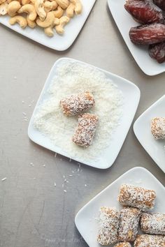 four plates with different types of food on them and nuts in the middle one is filled with powdered sugar