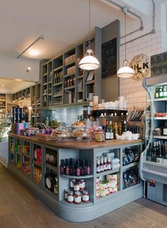 an open kitchen with lots of food and drinks on the counter in front of it