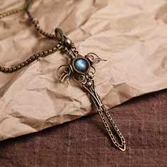 PRODUCT INFORMATION Material: brass, labradorite Chain: Length 50 cm (20 inches) Pendant: 3 x 7.7 cm (1.2 x 3 inches) Gift: nylon rope × 1, brass chain × 1, both length 50 cm (20 inches) Handmade Brass Cross Pendant Necklace, Medieval Brass Necklaces As Gift, Handmade Bronze Cross Pendant Necklace, Handmade Bronze Necklace With Cross Pendant, Handmade Medieval Brass Necklaces, Handmade Medieval Brass Necklace, Diy Wire Wrapped Pendant, Crafting Wire, Bijoux Fil Aluminium