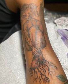 a man's arm with a tree tattoo on it