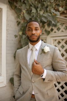 a man in a gray suit and white tie