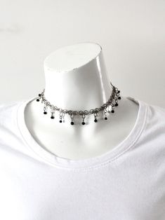 "This is a vintage choker necklace.  It features a filigree style chain with black beads and a hook closure. Also makes a cute wrap around bracelet. CONDITION In good condition with wear consistent with age and use.  MEASUREMENTS Length;  13.5\"  ..  34.3 cm Width:  3/4\"  ..  1.9 cm 1122114" Metal Choker With Black Beads For Gift, Black Beaded Metal Choker Gift, Metal Choker With Black Beads As A Gift, Black Beads Metal Choker As Gift, Black Wire Wrapped Jewelry For Festival, Adjustable Vintage Black Choker, Vintage Black Dangle Jewelry, Vintage Black Beads For Jewelry Making, Metal Choker Necklace With Black Beads