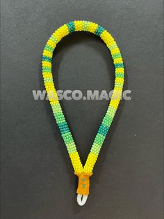 a yellow and green beaded lanyard with an orange hook