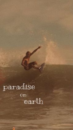 a man riding a surfboard on top of a wave in the ocean with words reading paradise on earth