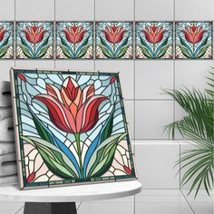 there is a vase with flowers on it next to the tile wall in this bathroom