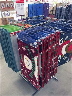 christmas sweaters are on display in a store