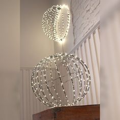 a metal ball with lights hanging from it