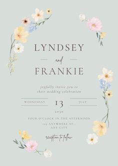 a wedding card with flowers on the front and bottom, in pastel blue background