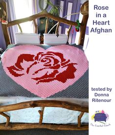 a crocheted rose in a heart afghan on a bed