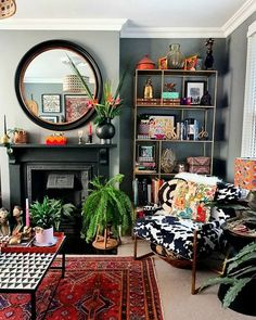 a living room filled with furniture and a fire place next to a mirror on the wall