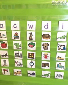 a green bulletin board with pictures of different things on it and words that spell out the word