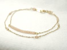 Double strand beaded bar bracelet - dainty jewelryTiny baby pink beads beaded on 14K gold filled chain.  Double chain bracelet that's femininely dainty in soft shades of gold and blushing pink.  >>>measurements<<<bead bar length 1"please choose length at checkout♦you can enter shop here!http://etsy.com/shop/illusy Delicate Pink Jewelry With Tiny Beads, Delicate Pink Everyday Bracelet, Delicate Beaded Bracelets With Satellite Chain, Dainty Double Strand Beaded Bracelets For Gift, Dainty Beaded Bracelets With Adjustable Chain, Delicate Beaded 14k Gold-filled Bracelets, Delicate Pink Beaded Bracelets For Everyday, Dainty Pink Beaded Chain Bracelet, Delicate Pink Beaded Bracelets