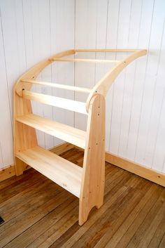 a wooden shelf sitting on top of a hard wood floor