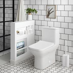 a white toilet sitting in a bathroom next to a magazine rack with magazines on it