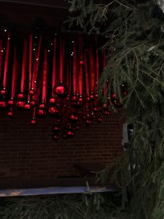 a christmas tree with red lights hanging from it's branches