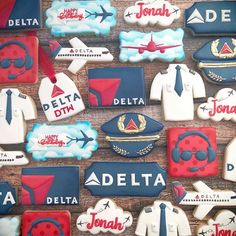 decorated cookies are arranged in the shape of shirts, ties, and airplane insignias