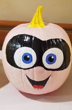 a painted pumpkin with an evil face on it